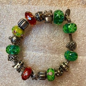 Pandora bracelet with 4 pandora charms and non brand charms as well.